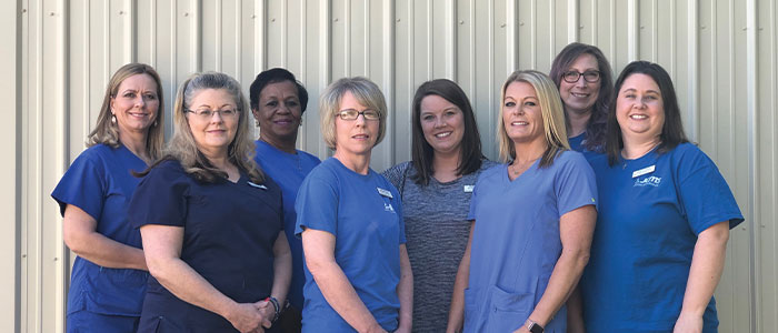 Staff members of Hattiesburg Medical Supply in front of CPAP display.